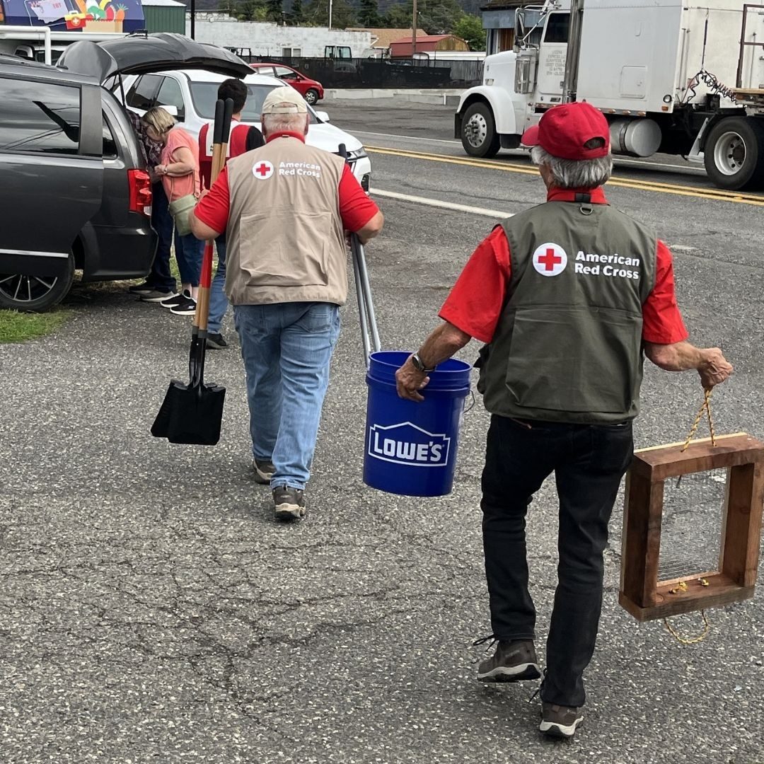 volunteers carrying supplies