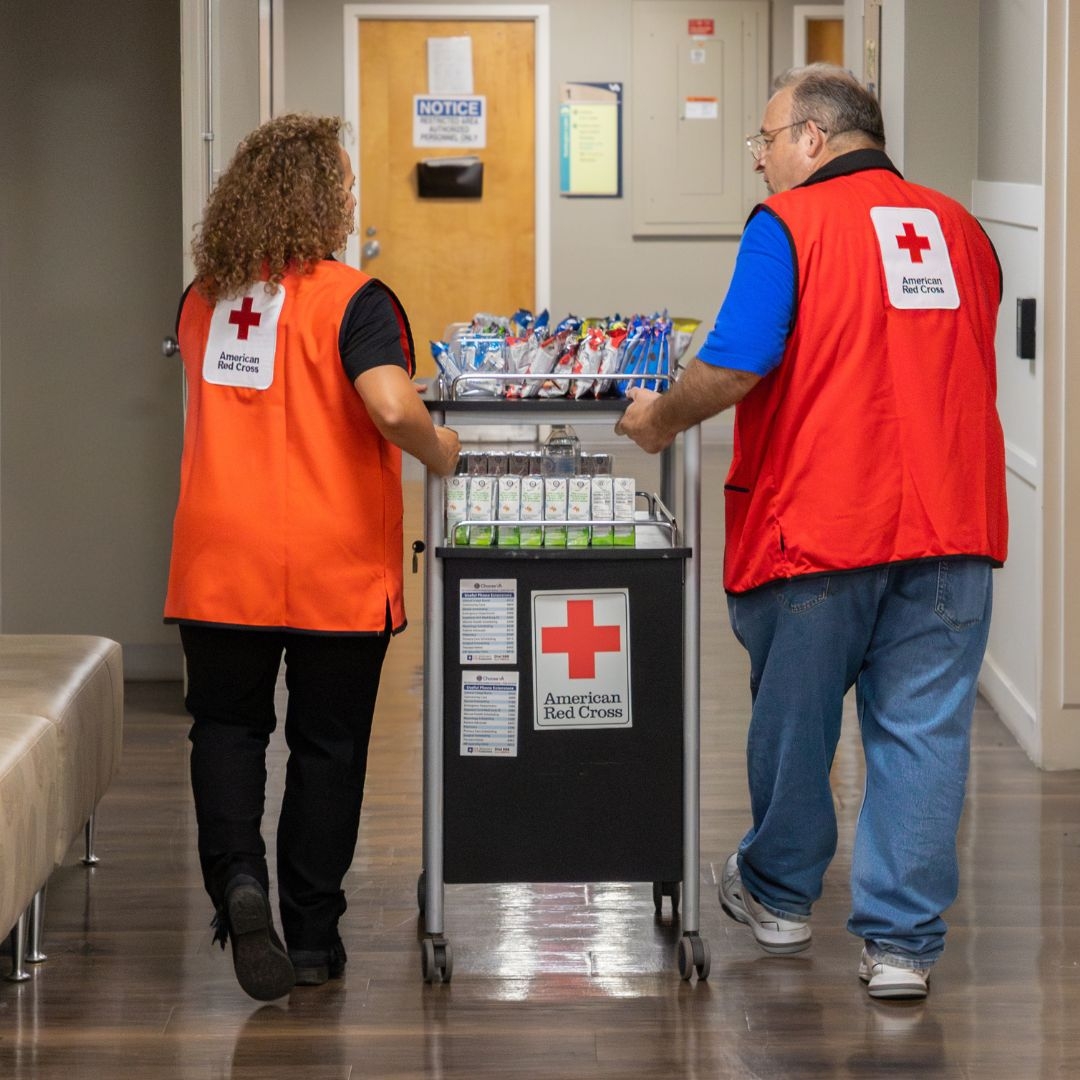 Service to Armed Forces volunteers walking with cart