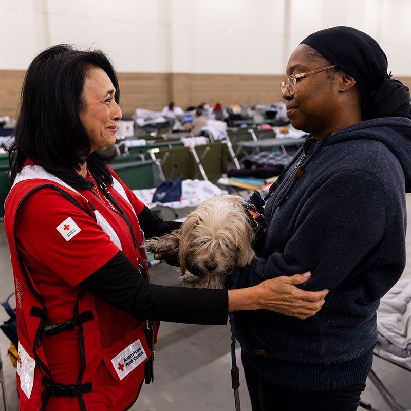 volunteer speaking with woman in shelter