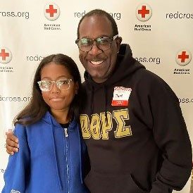 Amarey Brookshire and her dad, with his arm around her, at a Red Cross event.