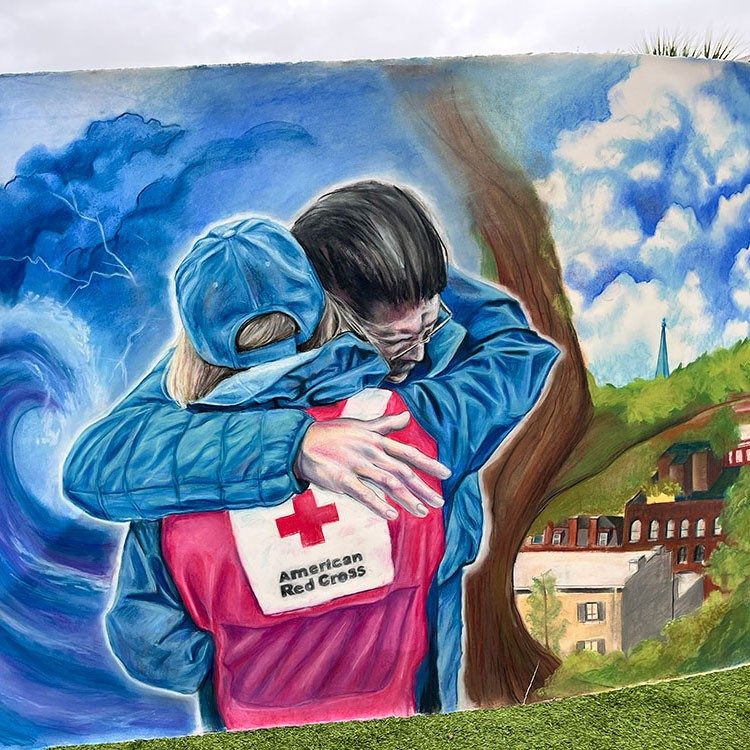 painting of a Red Cross volunteer embracing in a hug another person.