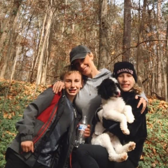 The Cook family: Cade, Ashley, Raylee and Bentley with a forest in the background.