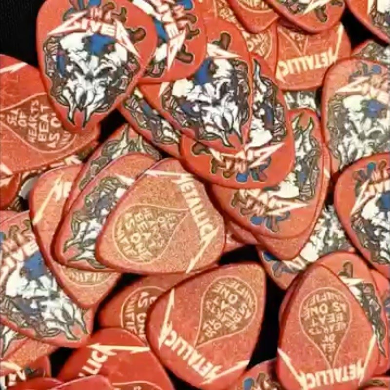 Pile of Metallica and AWMH blood drive guitar picks.