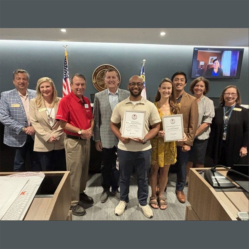 Raey Zirotti, holding Lifesaving Award, and Red Cross staff group pic.