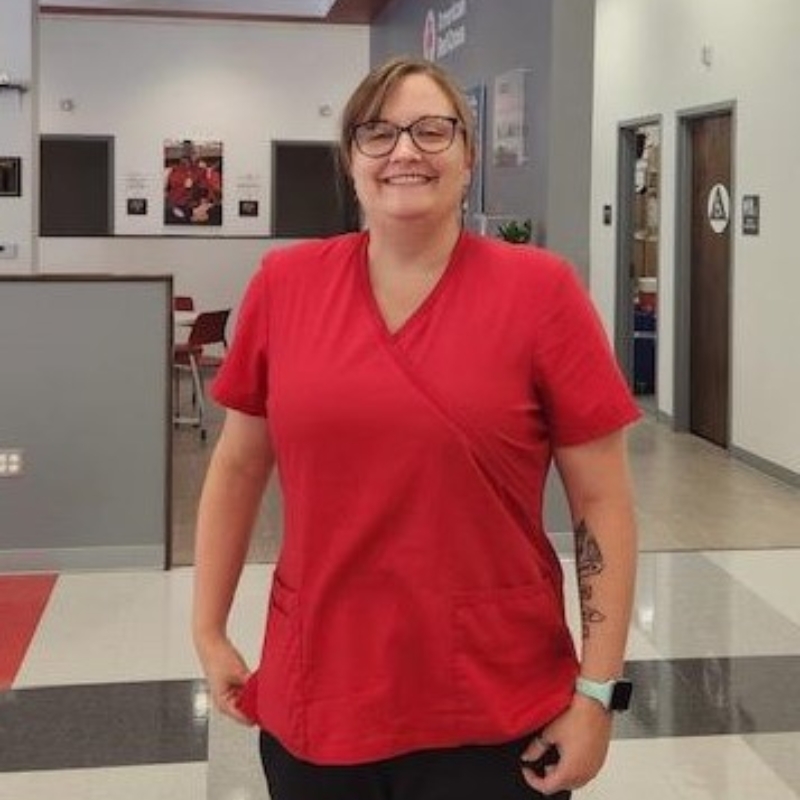 Breanna Hinkle in scrubs uniform smiling.