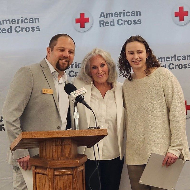 YMCA and Red Cross employees at a podium.