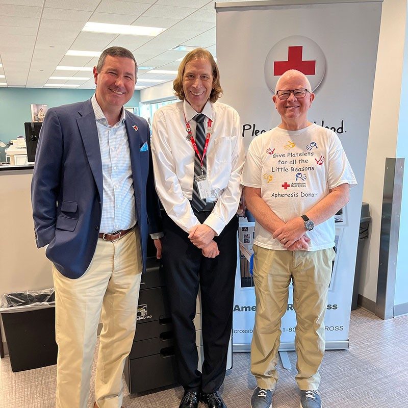 three people standing inside the renovated blood donor center at the Louisville office
