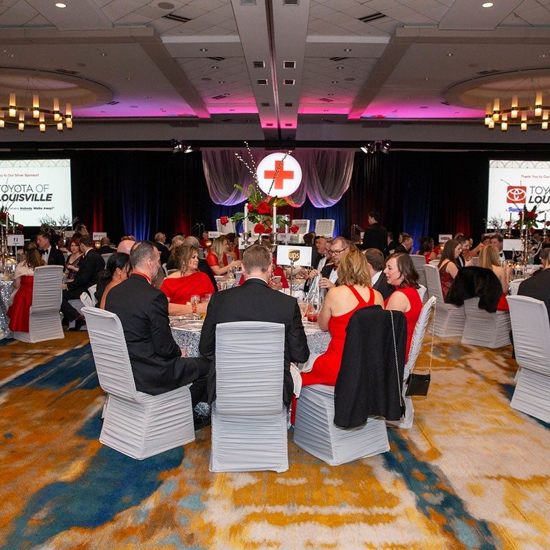 guests sitting at dinner table at the Wrapped in Red Gala.