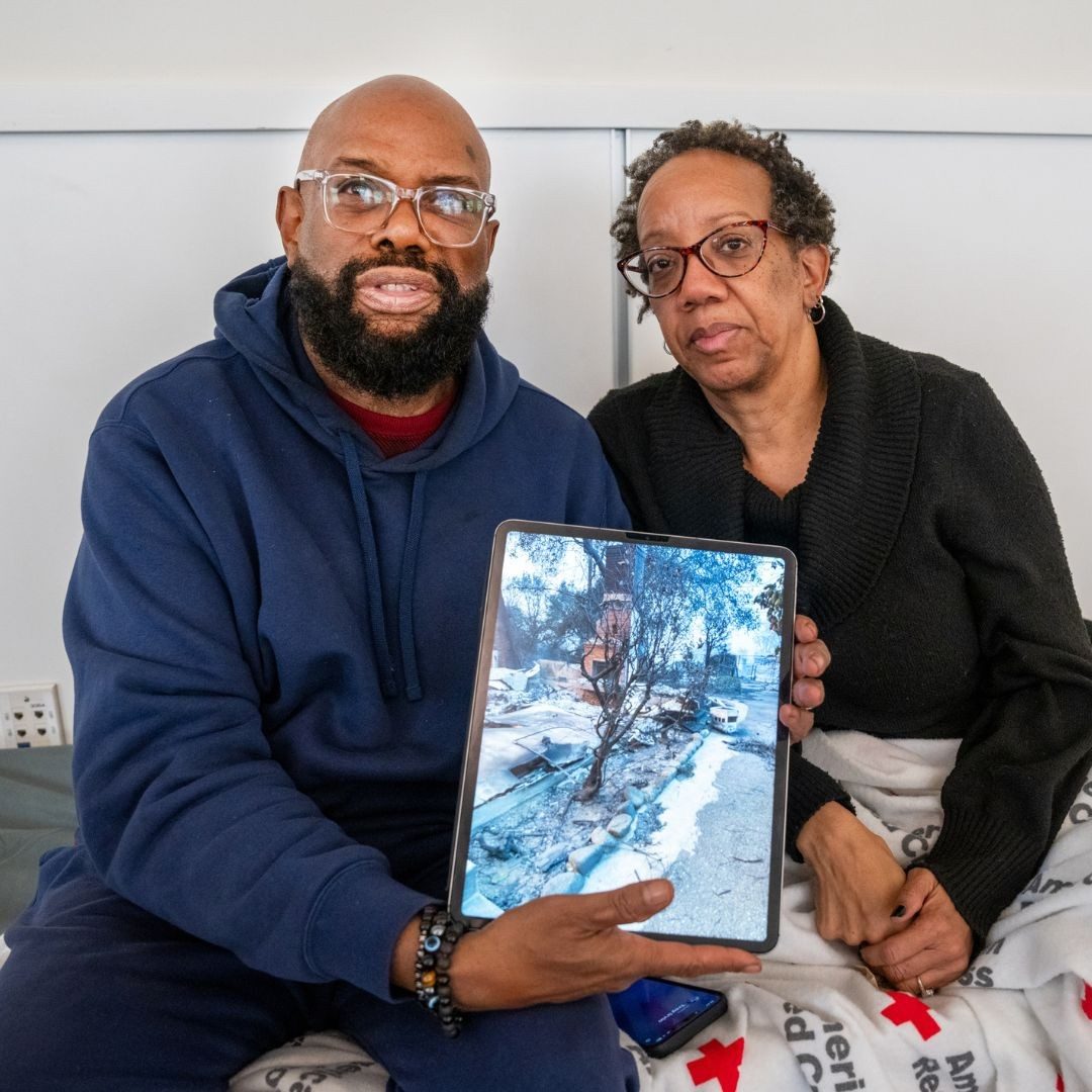 man and woman holding picture of home