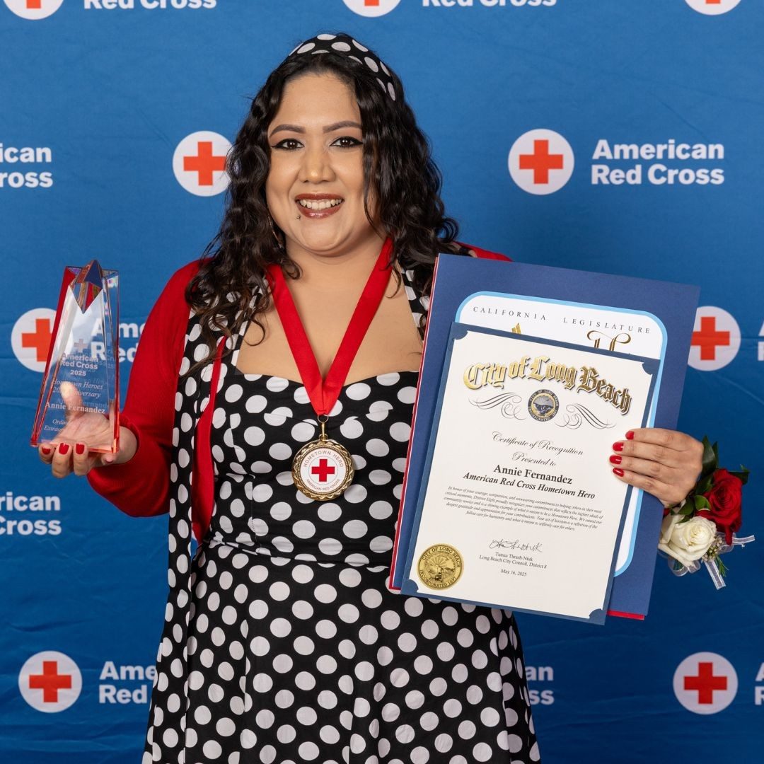 woman holding hometown heroes awards