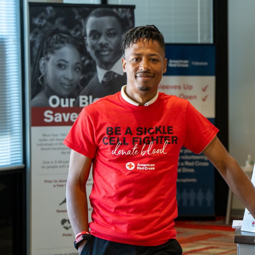 dorian archie in front of donate blood banner