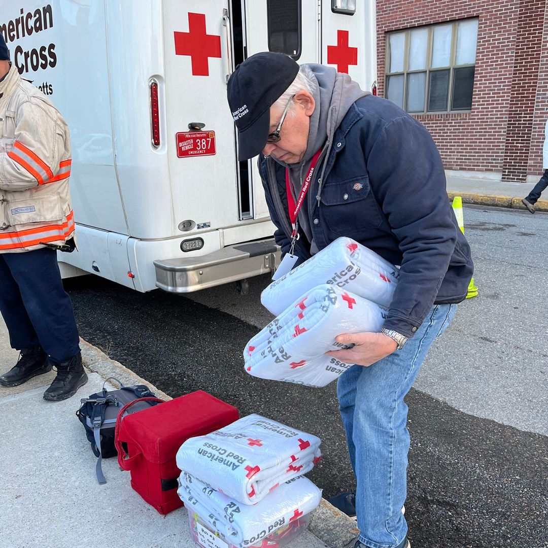 red cross volunteer sorting blankets