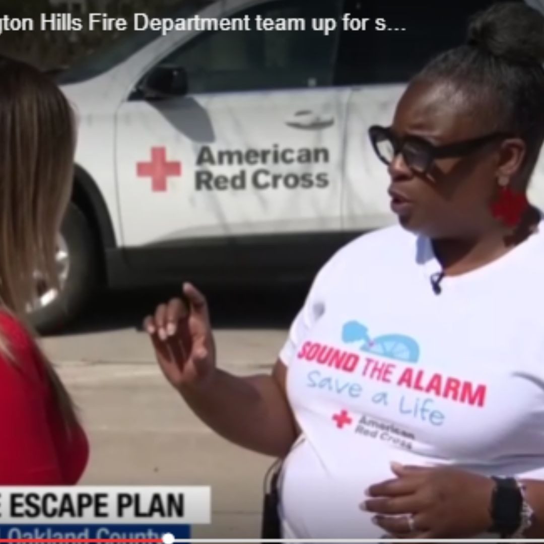 sound the alarm volunteer speaking with news reporter