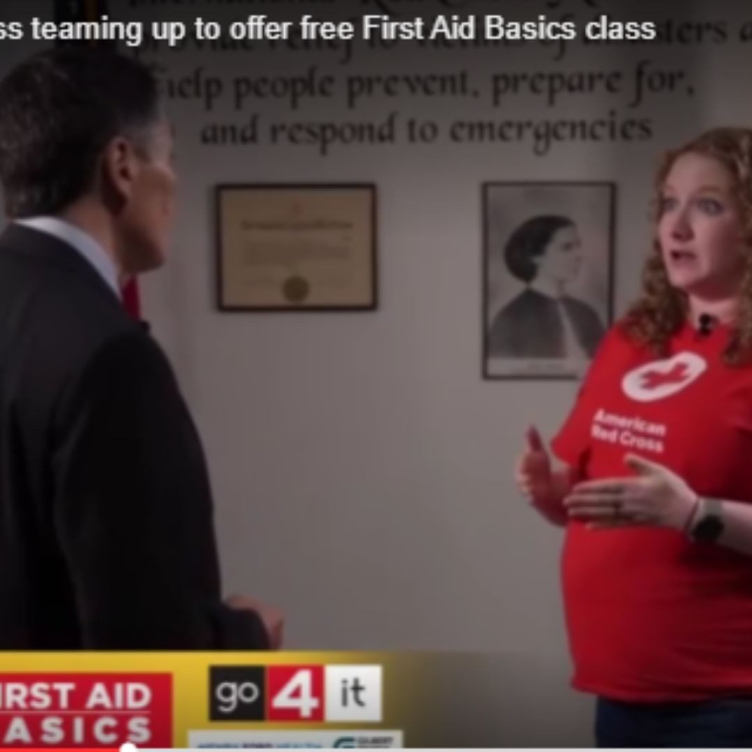 volunteer speaking with news reporter