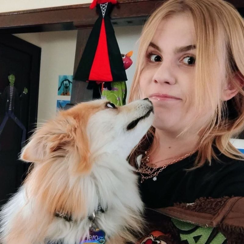 Makayla smiling with her dog.