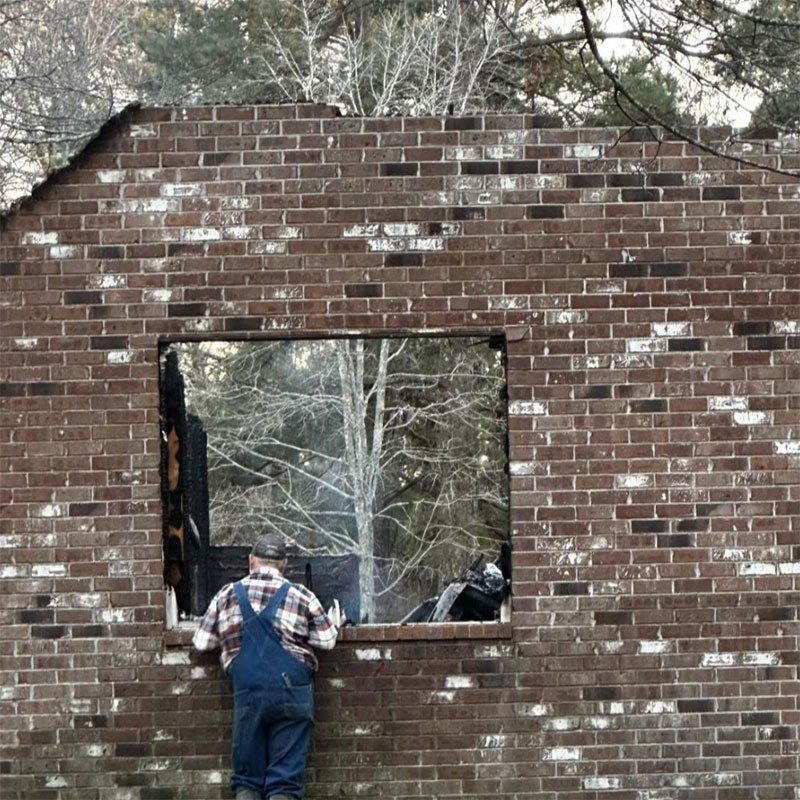 Robert Coleman looks at what is left of his home after the devastating fire.