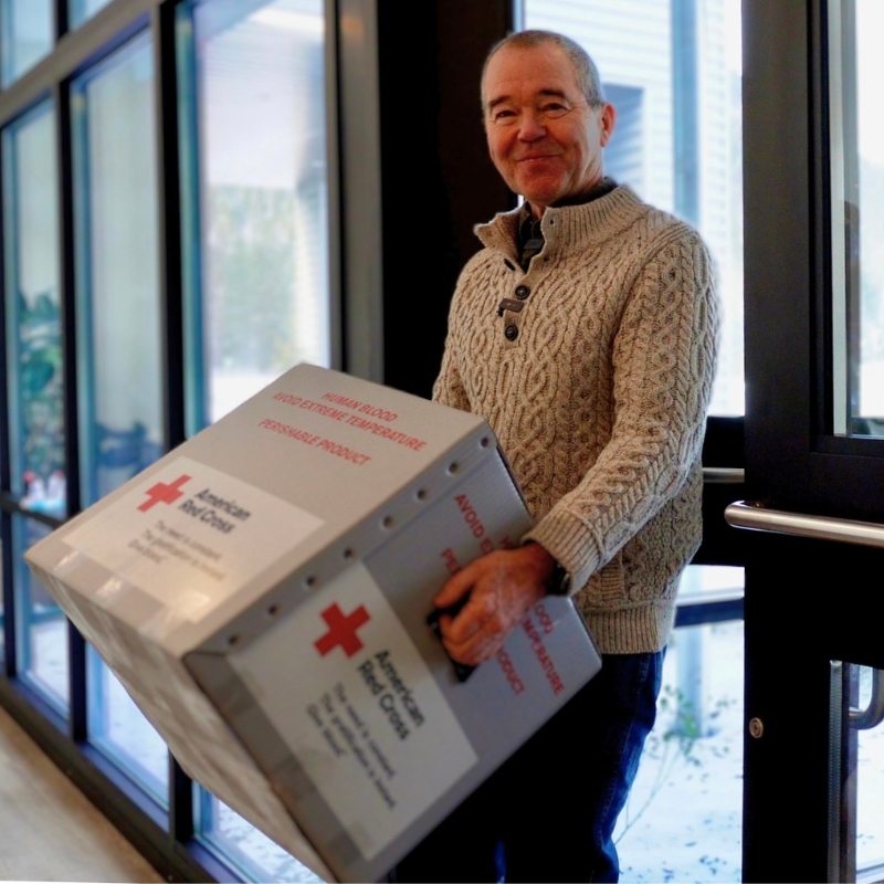 Wolf carrying a biomedical blood supply box.