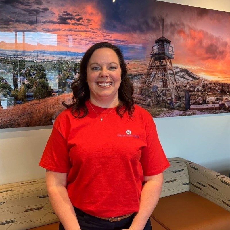 Breanna in a red shirt smiling.