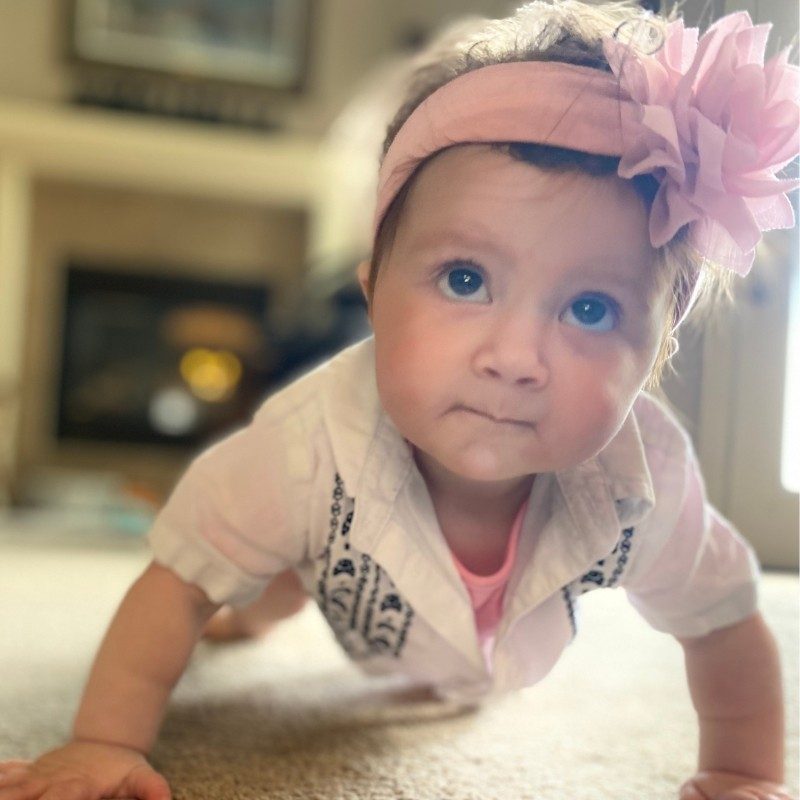 Bertie smiling while crawling.