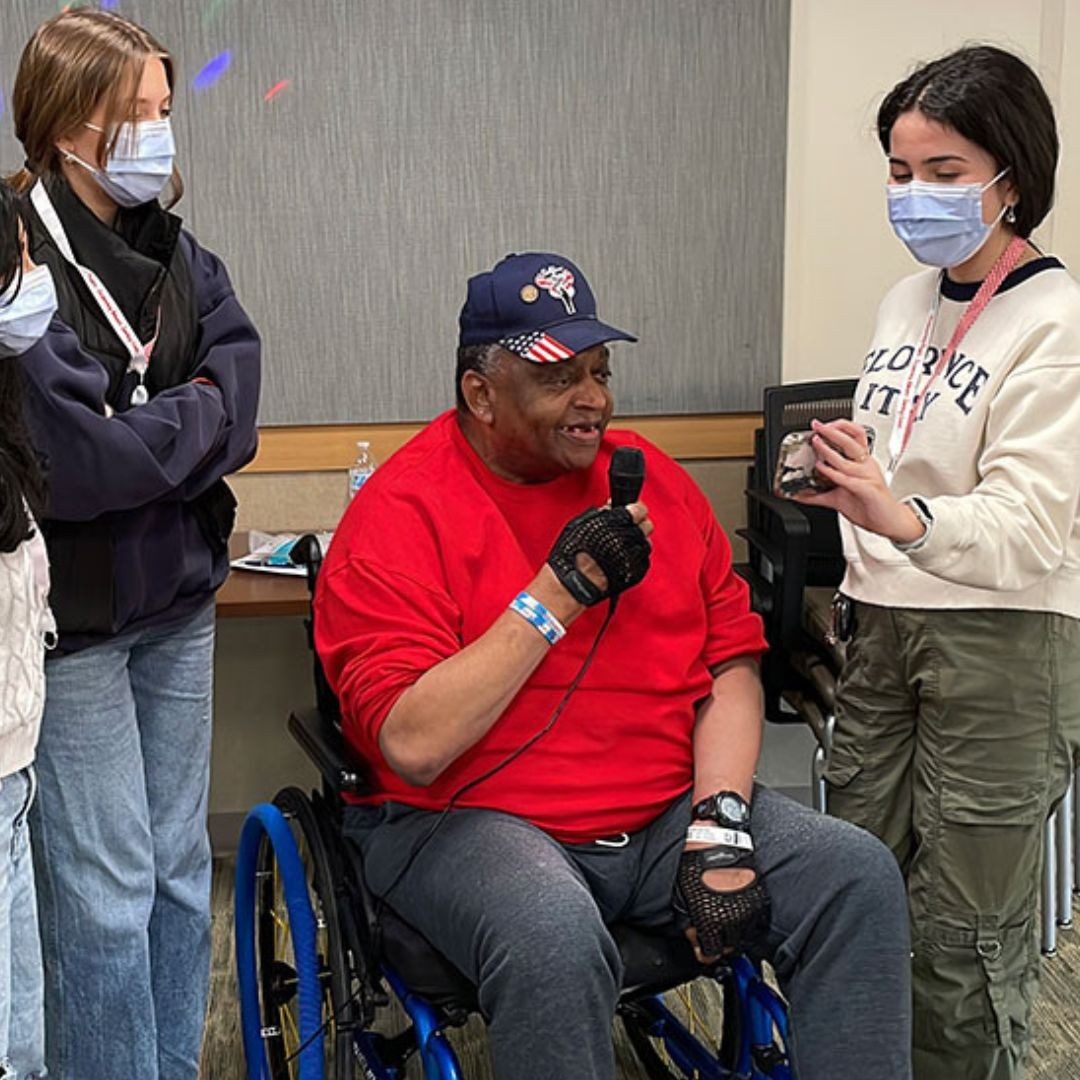 youth club members speaking with veteran