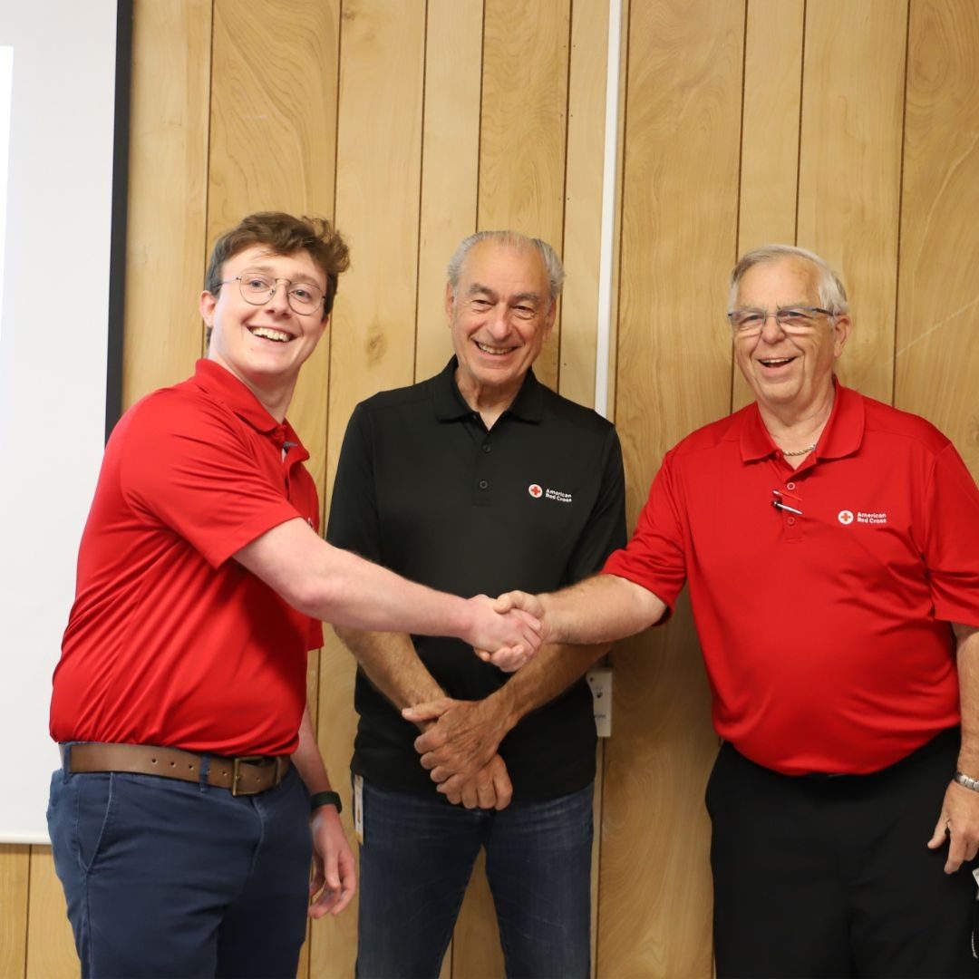 trio of red crossers shaking hands