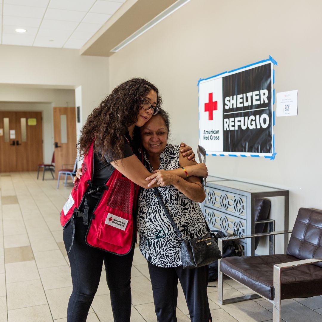 red crosser embracing woman