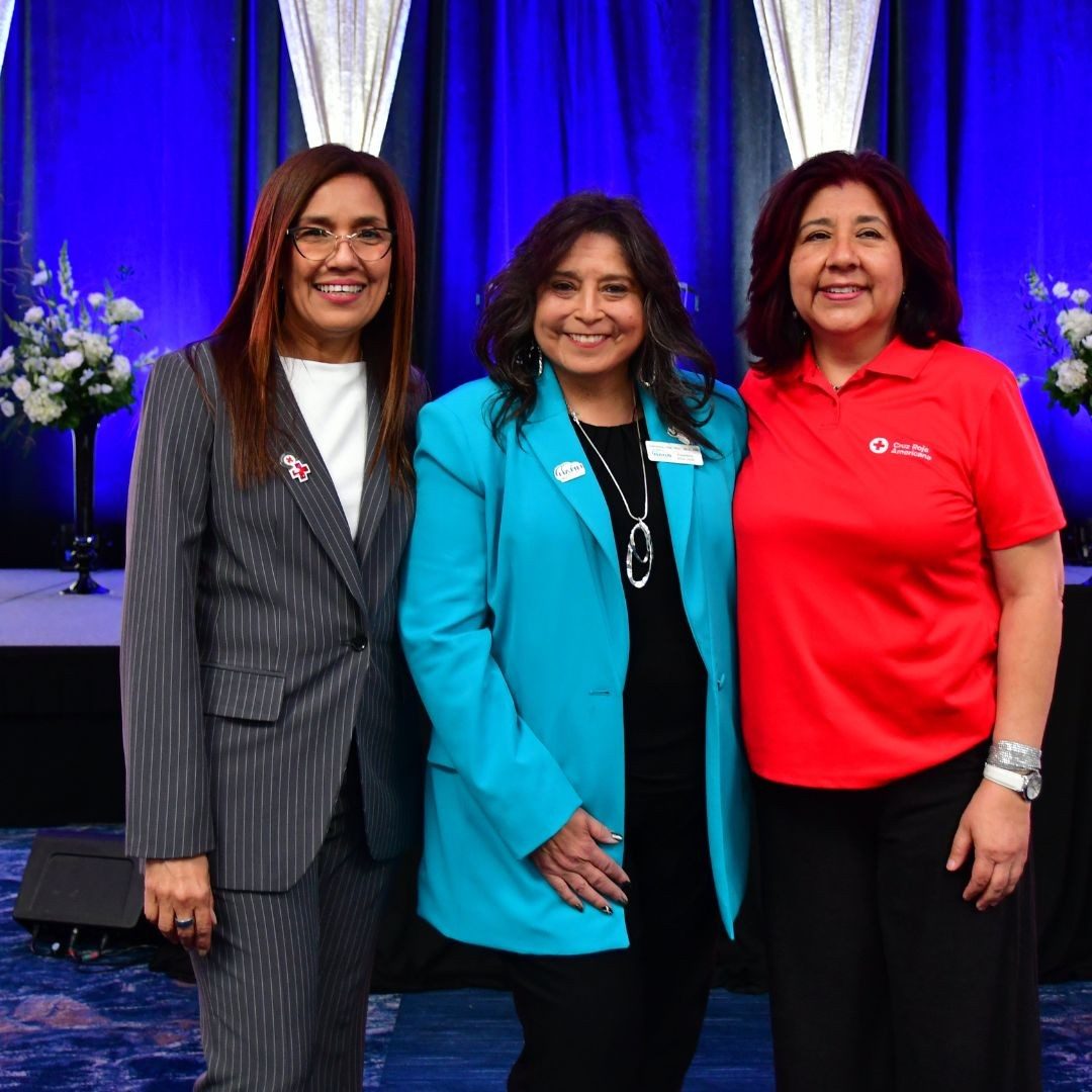 three women standing in front of banquet room