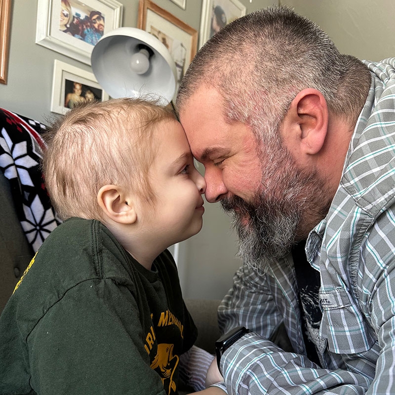 Lucy and Ivan Bellemare looking at each other with their foreheads touching.