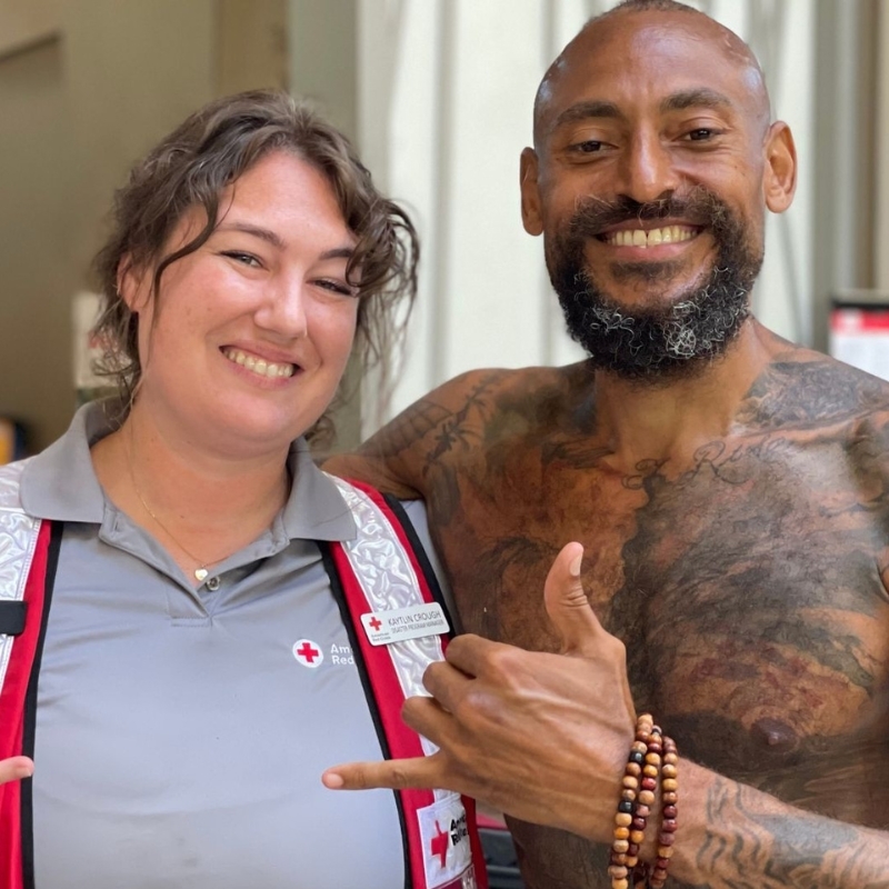 Red Cross volunteer smiling with client.