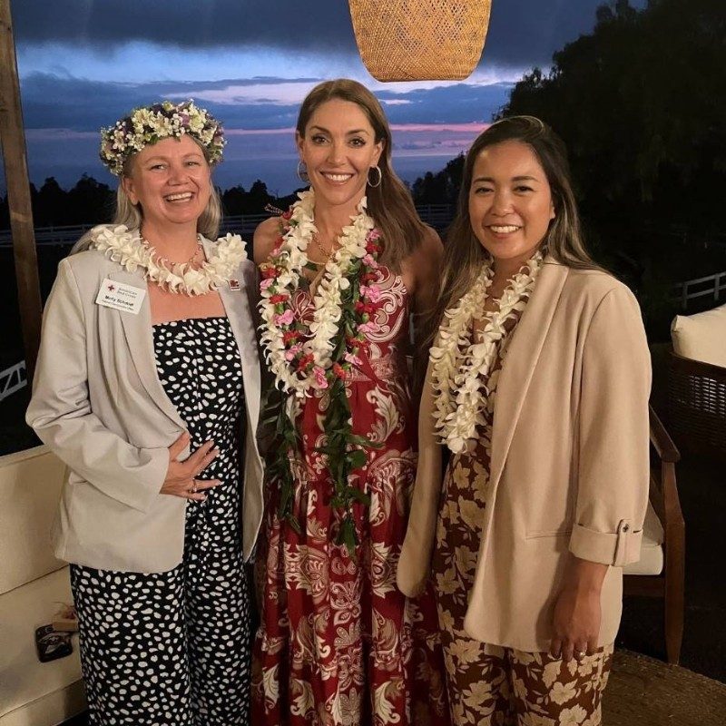 Three Tiffany Circle memebers in leis smiling posing for a picture.
