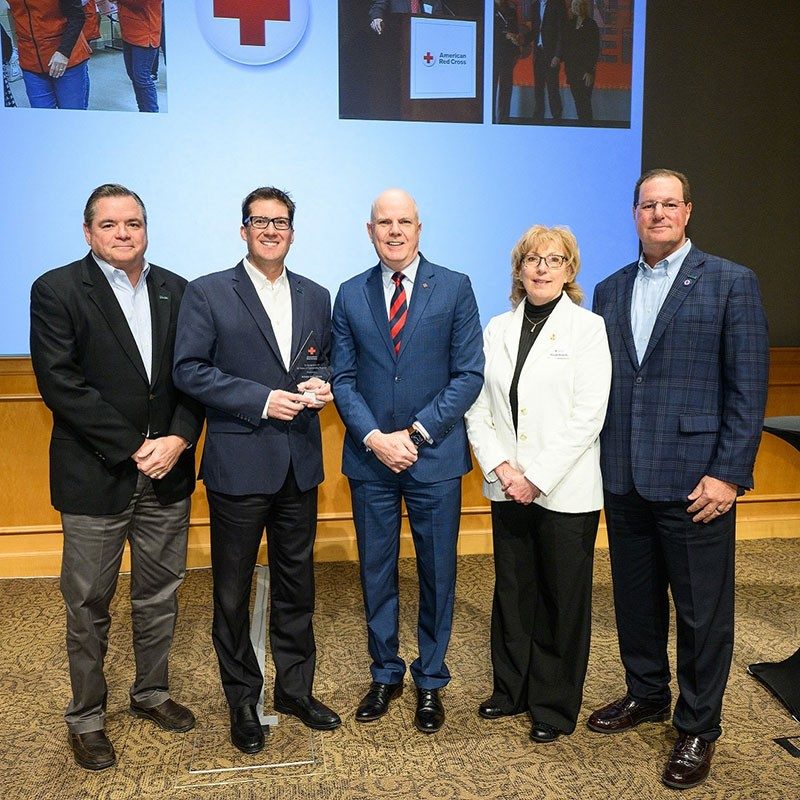 Group pic of five Amica members in work attire.