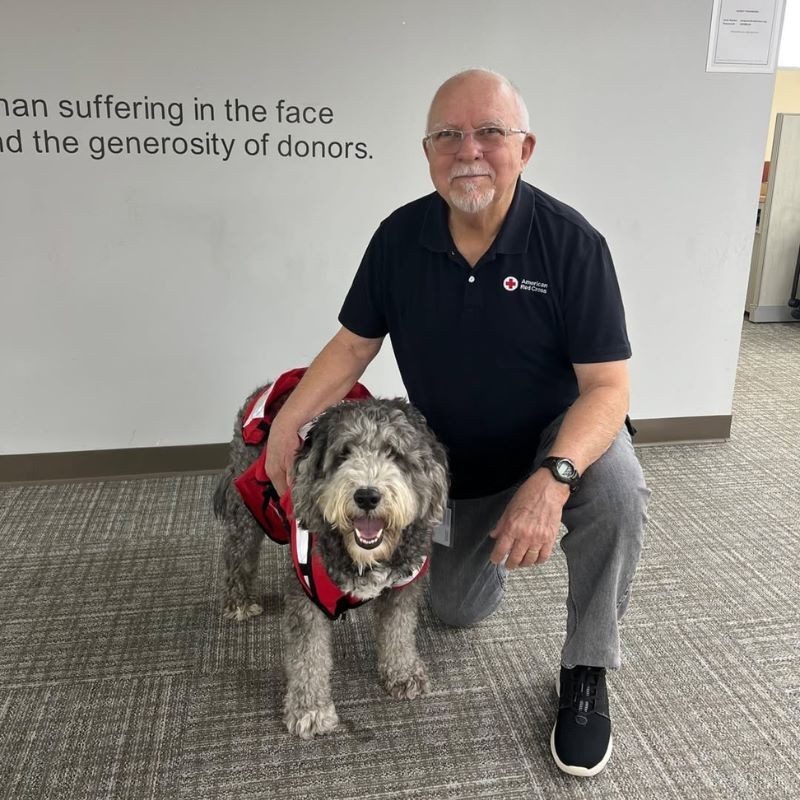 Pete Suarez and his dog posing for a picture.