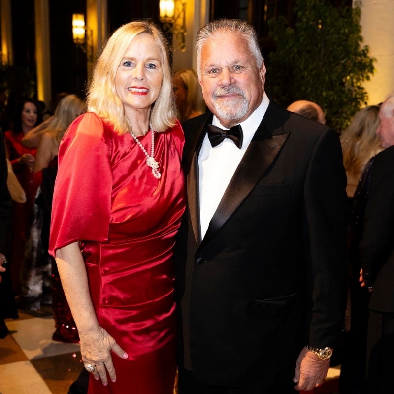 Mr. & Mrs. Kat Flanigan in formal wear smiling.