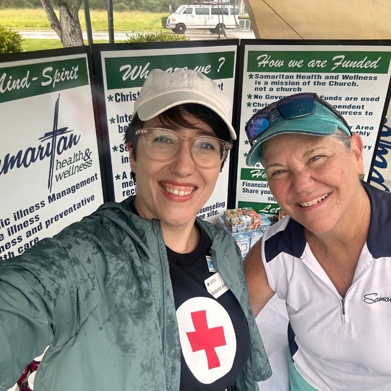 Two Red Cross volunteers smiling.
