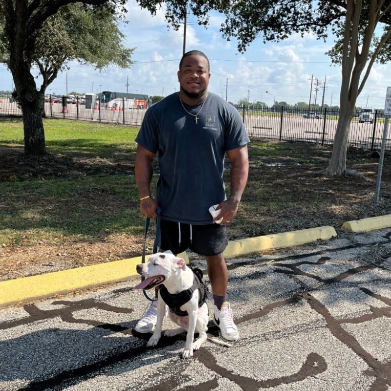 Philip satnding with his dog.