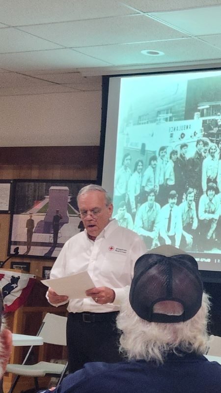 Bill Fisher presenting to a large group in a classroom.