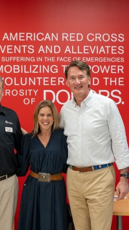 Governor and First Lady Youngkin posing with two Red Cross staff members.