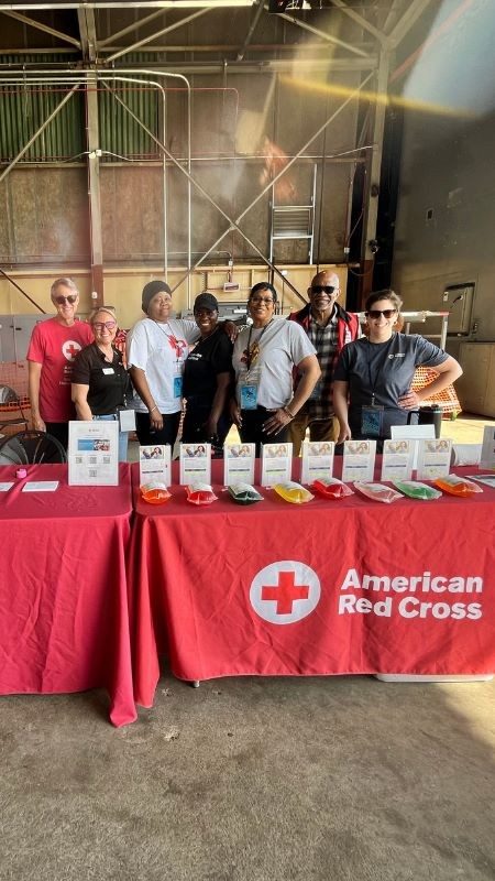 Group of Red Cross volunteers behind a table at the Langley Air Show 2025.