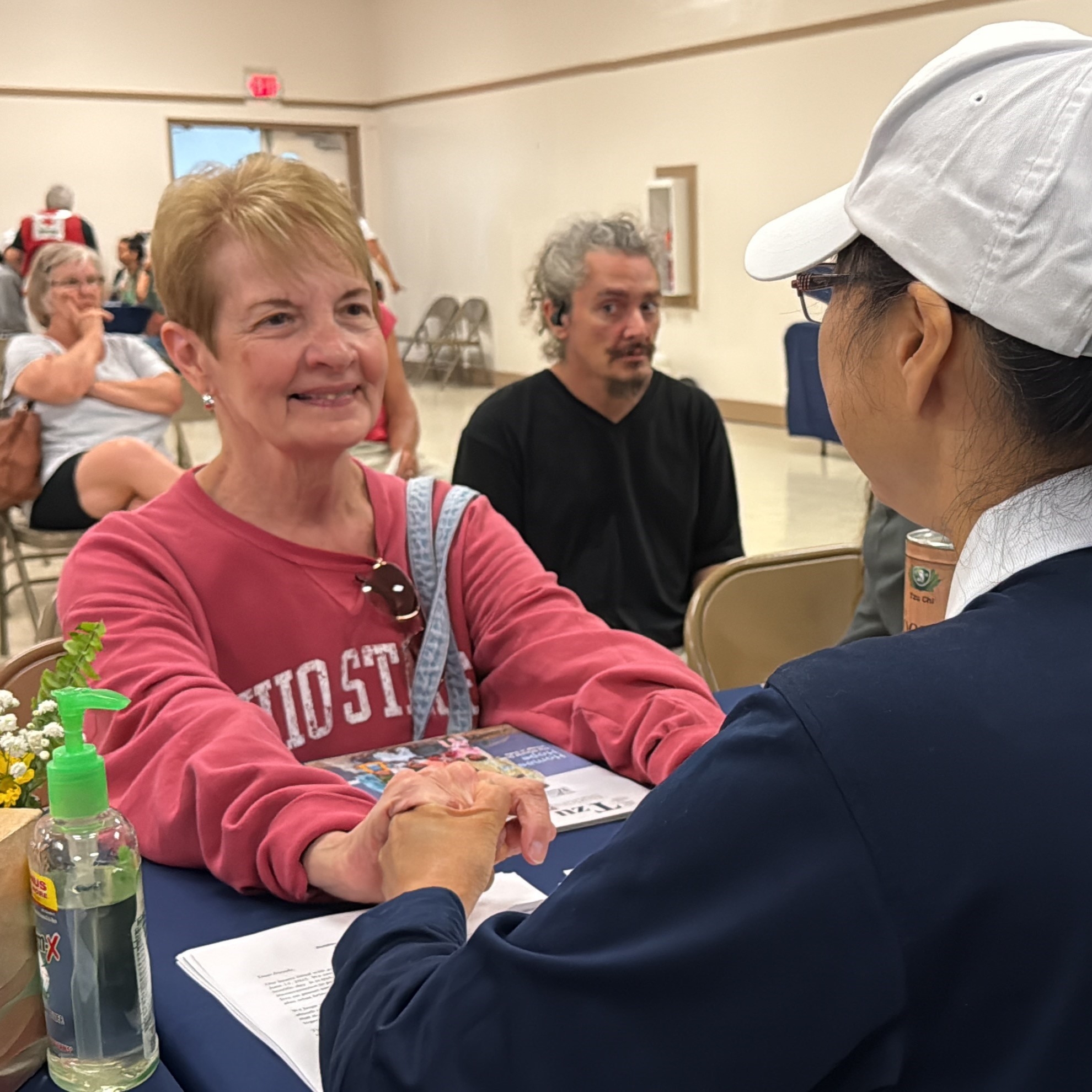 two women talking across table