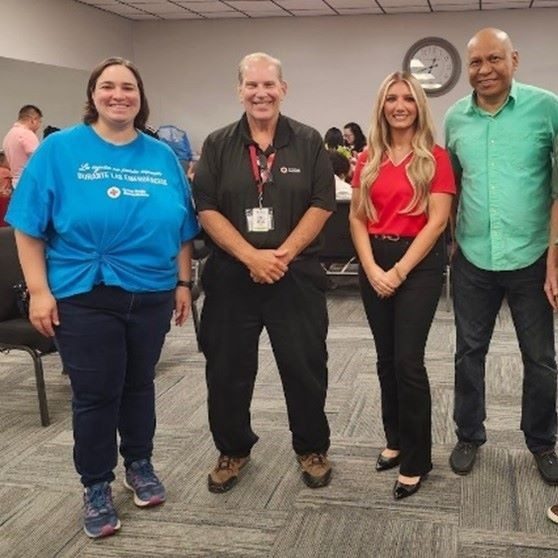 four people standing side by side 
