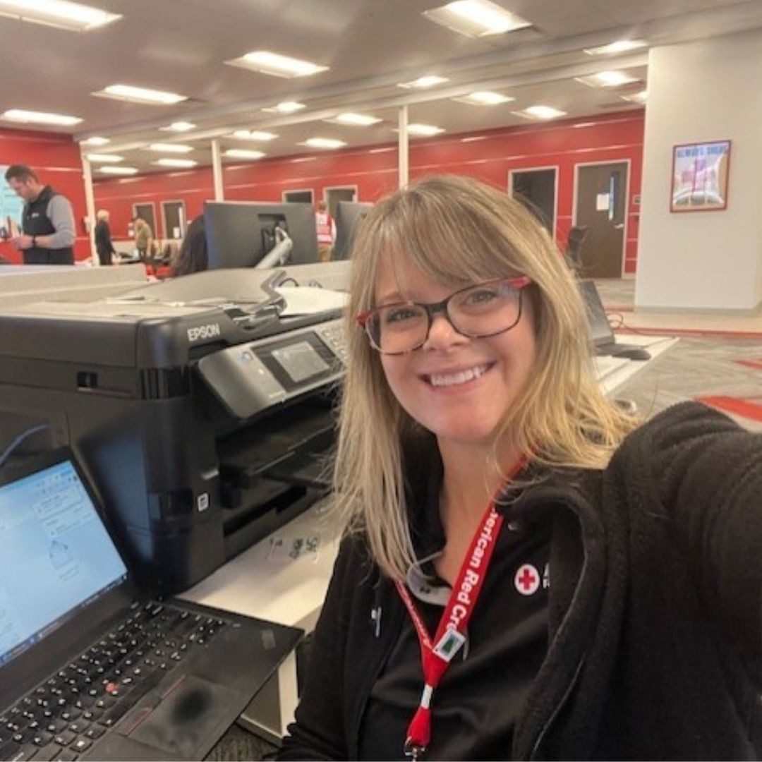 volunteer kari paterson sitting at computer desk