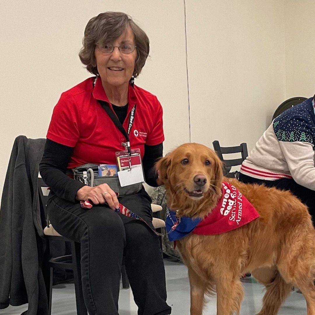 DeAnn sitting with golden retreiver.
