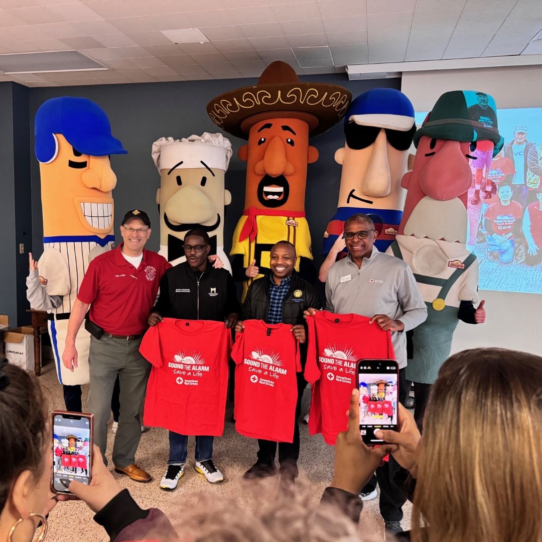 volunteers holding sound the alarm t-shirts