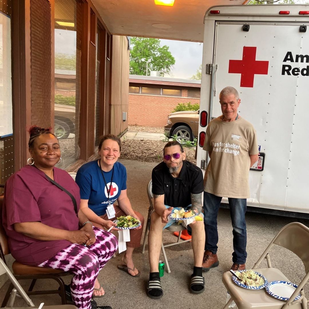 volunteers and residents sitting outside.