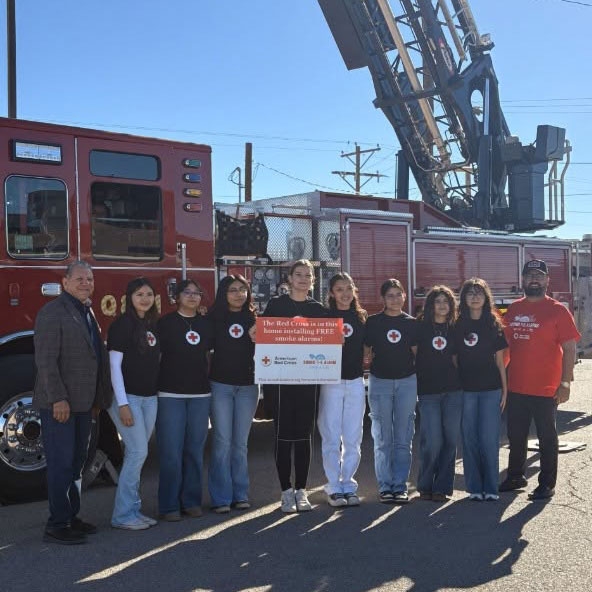 group picture of Red Cross volunteers in front of a fire engine at the Sound the Alarm event.