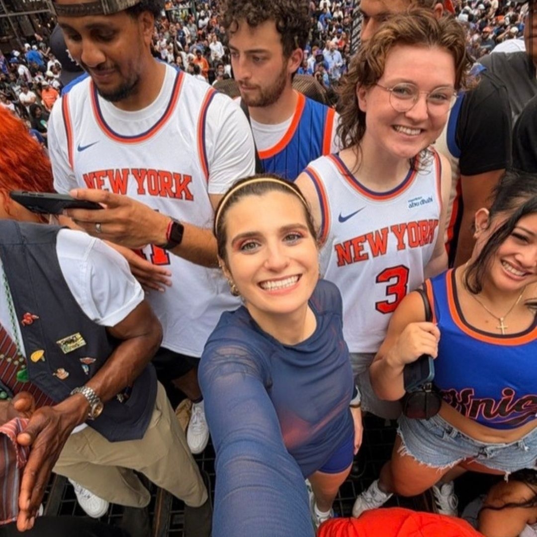 woman and group of knicks fans taking a selfie photo