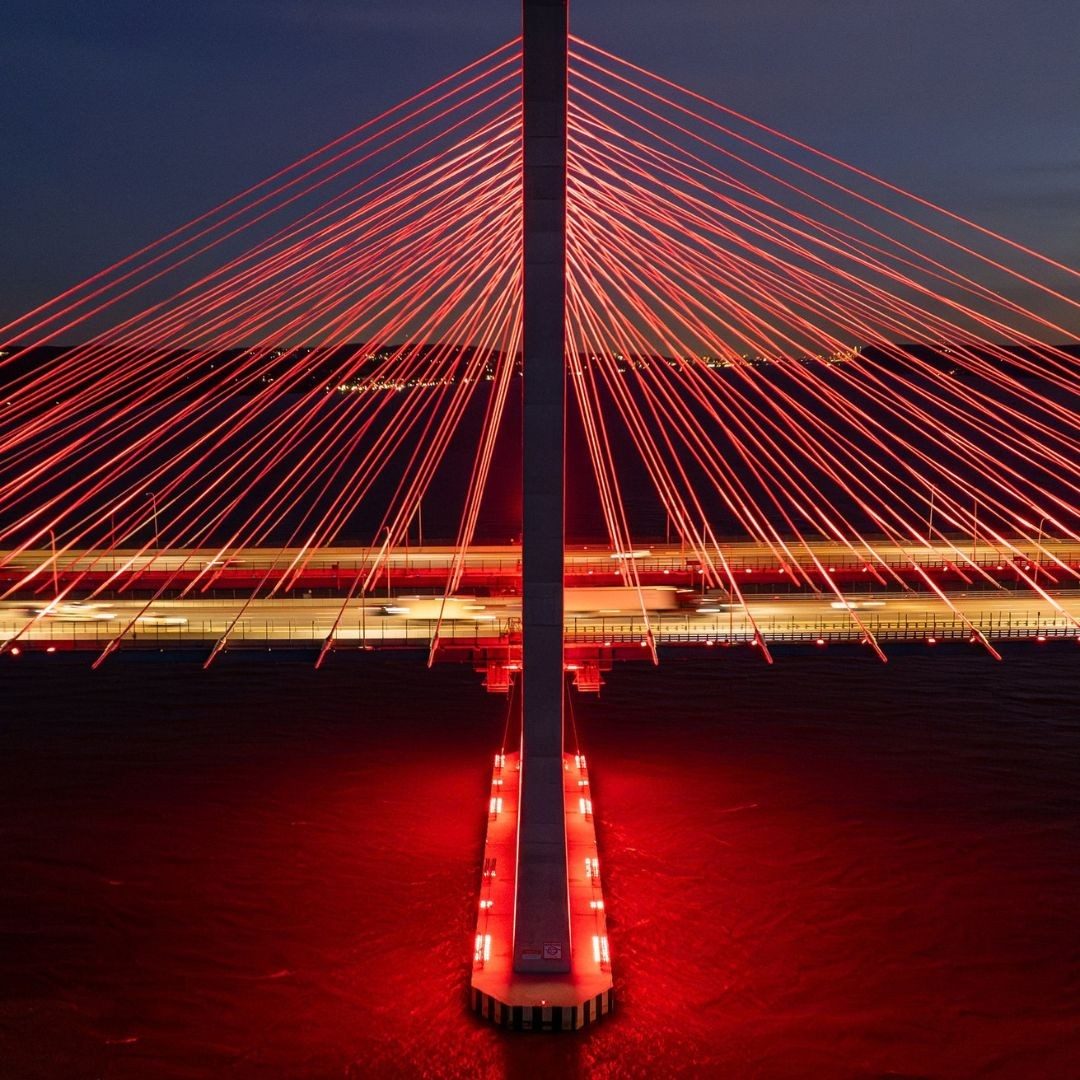 cuomo bridge lit in bright red during the night