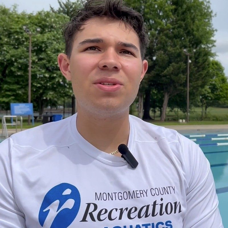 A young man at a pool.