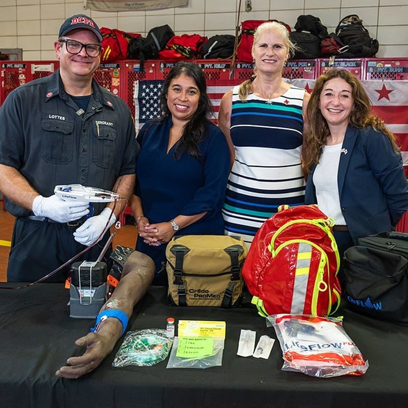 DC Fire and EMS with Red Cross partners standing at a table with first aid supplies.