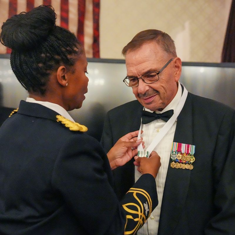 Red Cross volunteer James Gilbert recieving a medal.